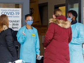 A nurse greets patients outside a coronavirus disease assessment centre in Ottawa, Ontario, Canada March 25, 2020.