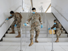 Members of Joint Task Force 2, composed of soldiers and airmen from the New York Army and Air National Guard, work to sanitize the New Rochelle High School during the COVID-19 outbreak in New Rochelle, New York, March 21, 2020.