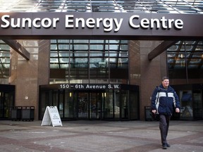 A pedestrian walks past the Suncor Energy Centre in Calgary, Monday, Feb. 1, 2010. A daycare in a downtown Calgary office tower has been closed after one of the children tested positive for COVID-19.