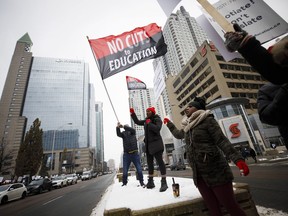 Striking teachers are seen picketing outside of the Toronto District School Board head office on Yonge Street in Toronto, Wednesday, Dec. 4, 2019. The union representing Ontario's public high school teachers says it is pausing its rotating strikes starting next week. The Ontario Secondary School Teachers' Federation says it will make the move to minimize the disruption to student activities scheduled during March break.