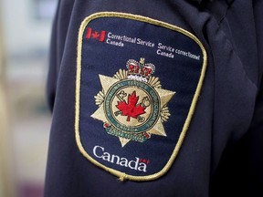 Patches are seen on the arm and shoulder of a corrections officer in the segregation unit at the Fraser Valley Institution for Women during a media tour, in Abbotsford, B.C., on Thursday October 26, 2017. A federal watchdog has found the federal prison service failed to ensure a safe work environment at a Quebec penitentiary.