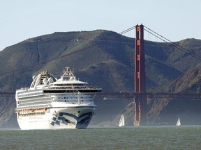 In this Feb. 11, 2020 photo, the Grand Princess cruise ship passes the Golden Gate Bridge as it arrives from Hawaii in San Francisco. Alberta's first presumptive case of the novel coronavirus involves a woman from the southern part of the province who was on a cruise ship that is being held for testing off the coast of California.