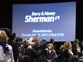 People embrace before the start a memorial service for Apotex billionaire couple Barry and Honey Sherman in Mississauga, Ontario on Thursday, December 21, 2017. A long-running case over whether the founder of the Apotex pharmaceutical company rooked his cousins out of a share of the company that was rightfully theirs has reached an end.