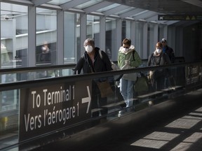 People leave after arriving at Pearson International Airport in Toronto on Monday, March 16, 2020. For one traveller returning to Toronto from Vietnam, the way officials handled arrivals to Canada was startling when compared to strict COVID-19 guidelines in the southeast Asian country.
