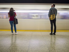 Commuters wait to take the subway at Ossington Station in Toronto on Friday, June 22, 2018. Some Canadian transit agencies are quietly taking steps to protect customers against the novel coronavirus that's been sounding alarm bells around the world.