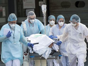 Medical staff push a patient on a gurney in France. More than 2,000 newly trained Canadian doctors are unsure of their futures after their qualifying exams were delayed by the COVID-19 pandemic.