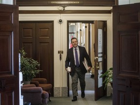 Alberta Premier Jason Kenney makes his way to the chamber as the Alberta Legislature sits through the weekend to pass a series of emergency bills, in Edmonton on Friday, March 20, 2020.