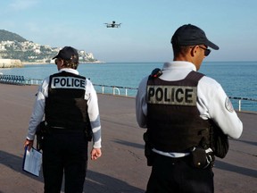Police officers use a drone to control people on the 'Promenade des Anglais' in the French Riviera city of Nice, on March 19, 2020, on the third day of a strict lockdown in France to stop the spread of COVID-19.