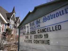 A sign announces all services have been cancelled due to COVID-19 at St. Saviour's Anglican Church in Toronto on Sunday, March 15, 2020.