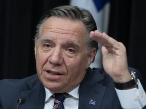 Quebec premier François Legault is among the Canadian politicians urging people with coronavirus symptoms to stay home.