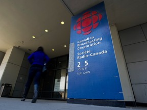 A woman approaches the entrance to CBC's headquarters in downtown Toronto in a file photo from April 4, 2012.
