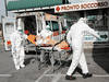 Medical workers in protective suits push a patient on a stretcher in front of the Policlinico Tor Vergata, where patients suffering from the COVID-19 coronavirus are hosted, in Rome, Italy March 30, 2020.