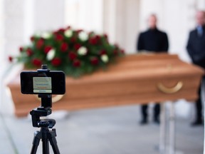 A camera is set up to live stream a funeral for a victim of COVID-19 in Vienna, Austria.