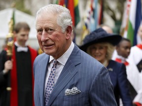 Britain's Prince Charles and Camilla the Duchess of Cornwall, in the background, leave after attending the annual Commonwealth Day service at Westminster Abbey in London, Monday, March 9, 2020.