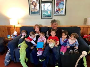 Catherine McLeod and her husband Paul Innes are seen in a March 2019 family handout photo surrounded by their grandkids. The couple are stuck on board a cruise ship where four people have died and several others have tested positive for COVID-19.