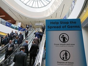 Visitors pass a sign warning about the spread of germs, after another case of the COVID-19 disease caused by the newly-identified coronavirus was confirmed in the city, at the Prospectors and Developers Association of Canada (PDAC) annual conference in Toronto, Ontario, Canada March 1, 2020.