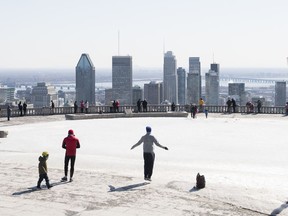 People gather at the Mount Royal lookout in Montreal, Saturday, March 21, 2020, as COVID-19 cases rise in Canada and around the world.THE CANADIAN PRESS/Graham Hughes