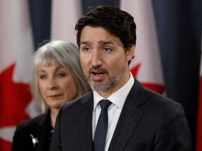 Canada's Prime Minister Justin Trudeau, with Canada's Minister of Health Patty Hajdu, speaks during a news conference in Ottawa, Ontario, Canada March 11, 2020.