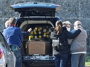 Relatives of a person who died of coronavirus disease (COVID-19) arrive at a cemetery in Bergamo, Italy on March 16, 2020.