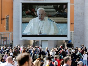 Pope Francis delivers his weekly Angelus prayer via video transmitted on the screen on St. Peter's Square, in Vatican March 8, 2020.