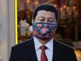 A cardboard cutout of Chinese President Xi Jinping wears a protective mask outside a gift shop in Moscow, Russia, on March 23, 2020.