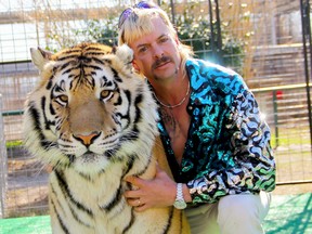 Michael Keaton look-alike Joe Exotic poses with one of his big cats in the crazy new documentary Tiger King.