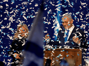 Confetti falls as Benjamin Netanyahu stands next to his wife Sara after speaking to supporters following the announcement of exit polls in Israel's election at his Likud party headquarters in Tel Aviv, Israel, March 3, 2020.