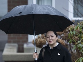 Meng Wanzhou chief financial officer of Huawei leaves her home to go to B.C. Supreme Court in Vancouver on January 23, 2020. The B.C. Supreme Court is considering creative ways to deliver a decision in an extradition hearing for Huawei executive Meng Wanzhou as a global pandemic restricts travel and gatherings.A court transcript shows Associate Chief Justice Heather Holmes convened a meeting Monday between Crown prosecutors, defence lawyers, Meng and her interpreter via teleconference.