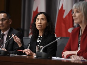Chief Public Health Officer of Canada Dr. Theresa Tam speaks as Minister of Health Patty Hadju, right, and Deputy Chief Public Health Officer Dr. Howard Njoo listen during a press conference on COVID-19 in West Block on Parliament Hill in Ottawa, on Thursday, March 19, 2020.
