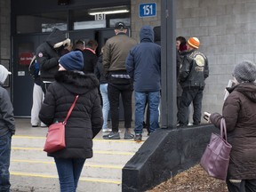 People line up outside the COVID-19 Assessment Centre at Brewer Park Arena in Ottawa, 40 minutes before it's scheduled noon opening on Friday, March 13, 2020. The assessment centre, operated by The Ottawa Hospital and CHEO, is an out-of-hospital clinic where people can be assessed and tested for COVID-19 if required.