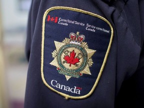 Patches are seen on the arm and shoulder of a corrections officer in the segregation unit at the Fraser Valley Institution for Women during a media tour, in Abbotsford, B.C., on Thursday October 26, 2017. A Saskatchewan union representing government workers says two corrections officers in Saskatoon have tested positive for COVID-19.