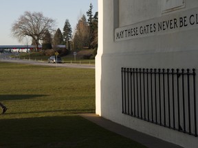A man walks past the Peace Arch at the Canada/USA border in Surrey, B.C. Friday, March 20, 2020. New restrictions in effect at midnight Friday along Canada's shared border with the United States focus more on blocking tourists and bargain-hunters than on clearing the way for so-called "essential" travel such as truckers hauling freight, health professionals and others who live on one side and work on the other.