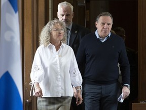 Quebec Premier Francois Legault, right, and Quebec Minister Responsible for Seniors and Informal Caregivers Marguerite Blais walk to a daily news conference on Saturday, March 14, 2020 at the legislature in Quebec City.