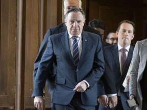 Quebec Premier Francois Legault walks to question period after meeting the party leaders at his office to discuss the next steps to take about the coronavirus, Thursday, March 12, 2020 at the legislature in Quebec City.