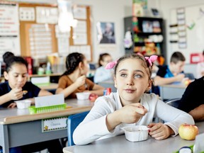 Students eat lunch at their desks at school