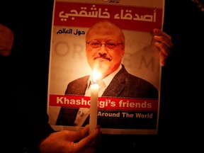 A demonstrator holds a poster with a picture of Saudi journalist Jamal Khashoggi outside the Saudi Arabia consulate in Istanbul, Turkey October 25, 2018.