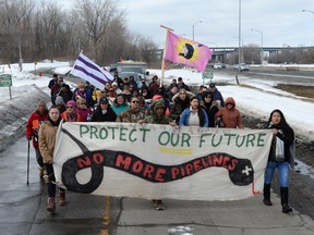 People leave the site after a blockade in the Mohawk community of Kahnawake, Que. that has halted rail traffic south of Montreal for more than three weeks is dismantled, on Thursday, March 5, 2020.
