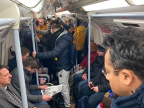 London commuters pack subway on the morning of the first day of lockdown