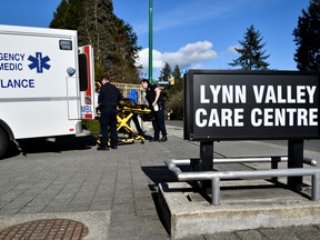 A paramedic removes protective gear outside the Lynn Valley Care Centre, a seniors care home which housed a man who was the first in Canada to die after contracting novel coronavirus, in North Vancouver, British Columbia, Canada March 9, 2020.