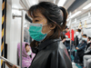 Commuters wear protective masks in the subway in Beijing, China, due to the COVID-19 pandemic.