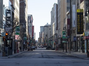 A nearly empty Saint-Catherine Street is seen in Montreal, Quebec, Canada, on Friday, March 27, 2020.