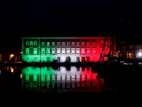 The Navy base is seen illuminated with the colours of the Italian flag, as Italy struggles to contain the spread of coronavirus disease (COVID-19), in Naples, Italy March 29, 2020.