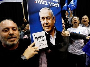 Supporters of Benjamin Netanyahu, Israel's prime minister and leader of the Likud party, react after exit poll results are announced at the Likud party headquarters in Tel Aviv on March 2, 2020.
