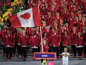 In this file photo taken on August 5, 2016 Canada's flagbearer Rosannagh Maclennan leads her delegation during the opening ceremony of the Rio 2016 Olympic Games at the Maracana stadium in Rio de Janeiro.