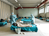 Medical personnel care for patients in an emergency temporary room, set up to ease pressure on the healthcare system caused by the coronavirus pandemic, at a hospital in Brescia, Italy, on March 13, 2020.