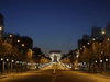 An empty Champs-Elysees Avenue and the Arc de Triomphe in Paris, at night on March 24, 2020, on the eight day of a lockdown aimed at curbing the spread of the COVID-19 coronavirus.