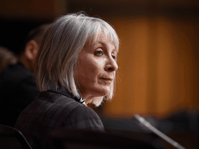 Health Ministr Patty Hajdu listens during a press conference on COVID-19 in Ottawa.