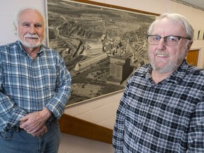 Francesco Spertini, left, and Mario Leblanc are seen in front of a historical picture of the open pit mine in Asbestos, Que. on Wednesday, March 11, 2020.