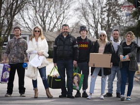 Jordan Banman, left to right, Jennifer Teufel-Shatilla, Mason Shatilla, Dave Shatilla, Zack St. Pierre, Sarah Moreby and Tori Teufel pose for a photo in their Burlington, Ont. neighbourhood on Monday, March 16, 2020. Jennifer Teufel-Shatilla is volunteering herself and her family and friends to run errands for seniors, single moms, and anyone else who needs it during the COVID-19 pandemic.THE CANADIAN PRESS/Peter Power