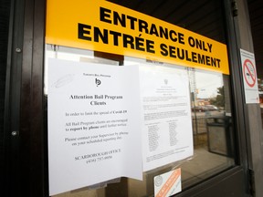 A notice is displayed outside a Toronto court after somebody received a presumptive positive diagnosis of COVID-19.